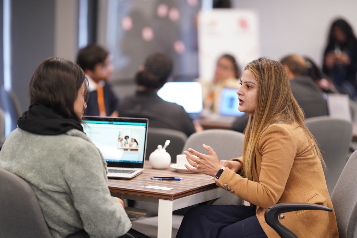 Mentor and participant in conversation at the Bank the Unbanked Ideathon